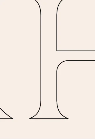 Cropped serif letter on a cream background, elegant minimalist typography.
